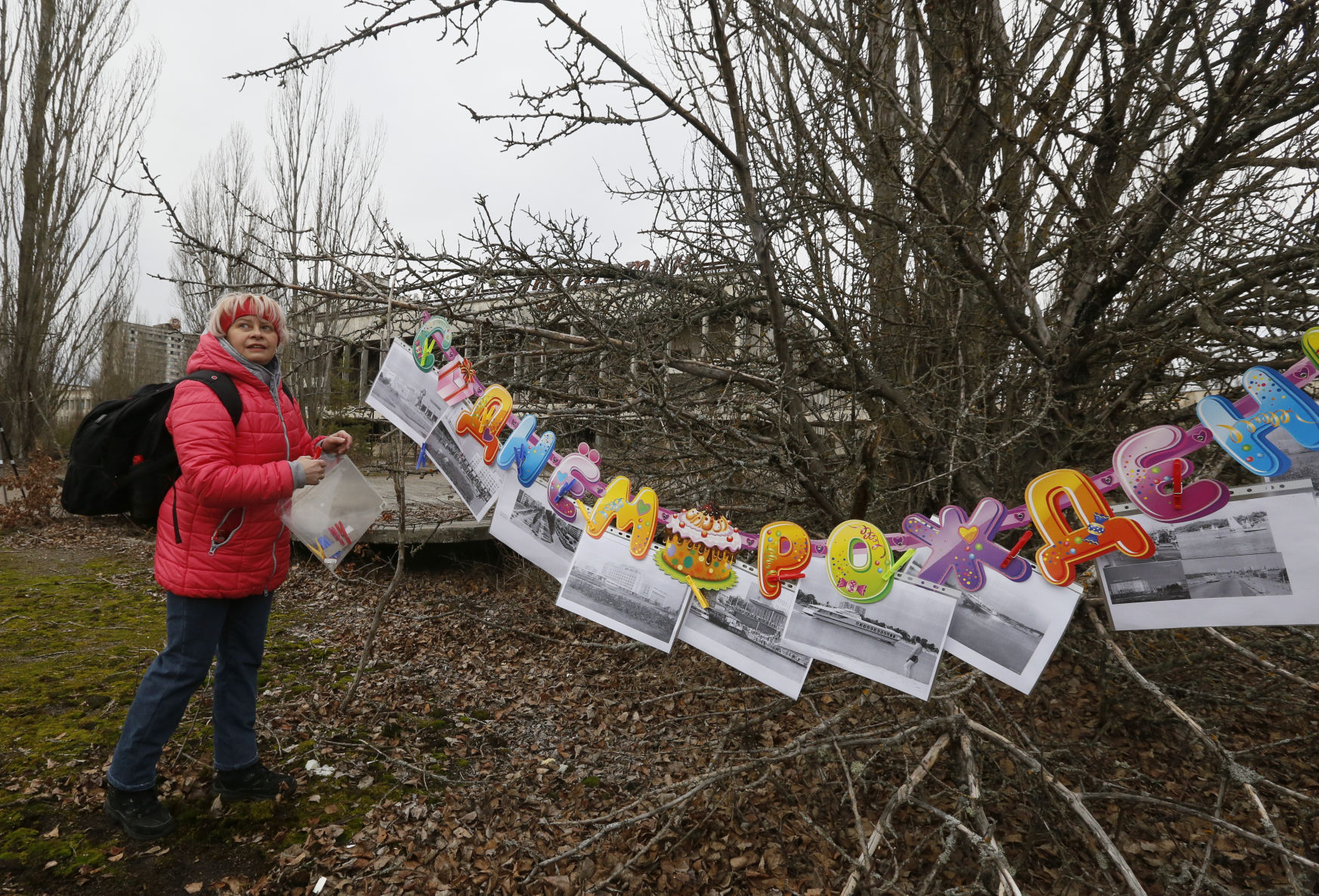A former resident of Pripyat hangs a photo of the city